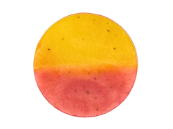 circle soap thats half yellow and half pink with strawberry seeds