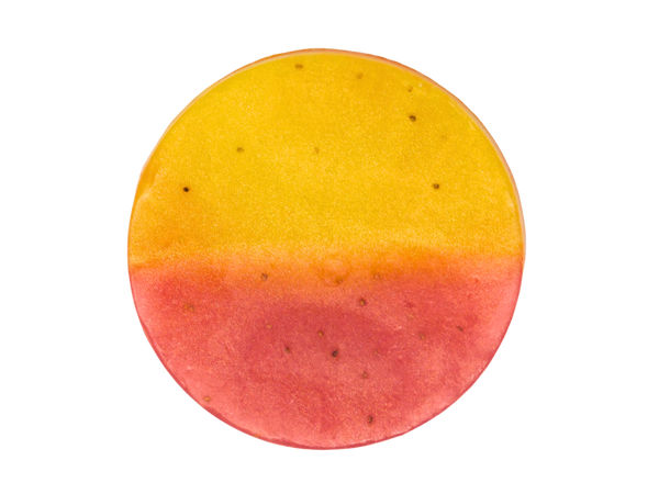 circle soap thats half yellow and half pink with strawberry seeds