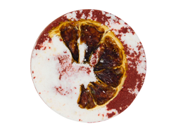 circular half red and white blood spatter appearance bath bomb with a blood orange pressed on top