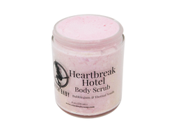 pink body scrub with clear front label that reads heartbreak hotel body scrub. bubblegum & eternal youth. 