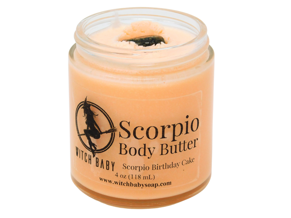 4 oz glass jar filled with orange body butter and topped with unakite. clear label reads: Scorpio Body Butter. Scorpio Birthday Cake. 