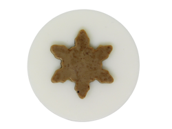 circular white soap topped with coffee colored and speckled snowflake