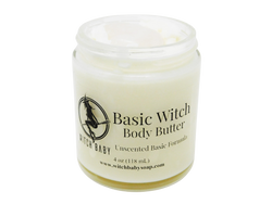 4 oz glass jar containing white body butter topped with milk quartz. Label says unscented basic formula. 