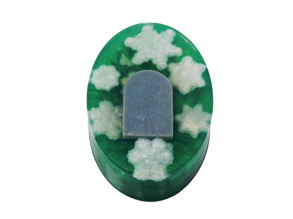 green oval soap with white snowflakes and a grey tombstone embedded inside 